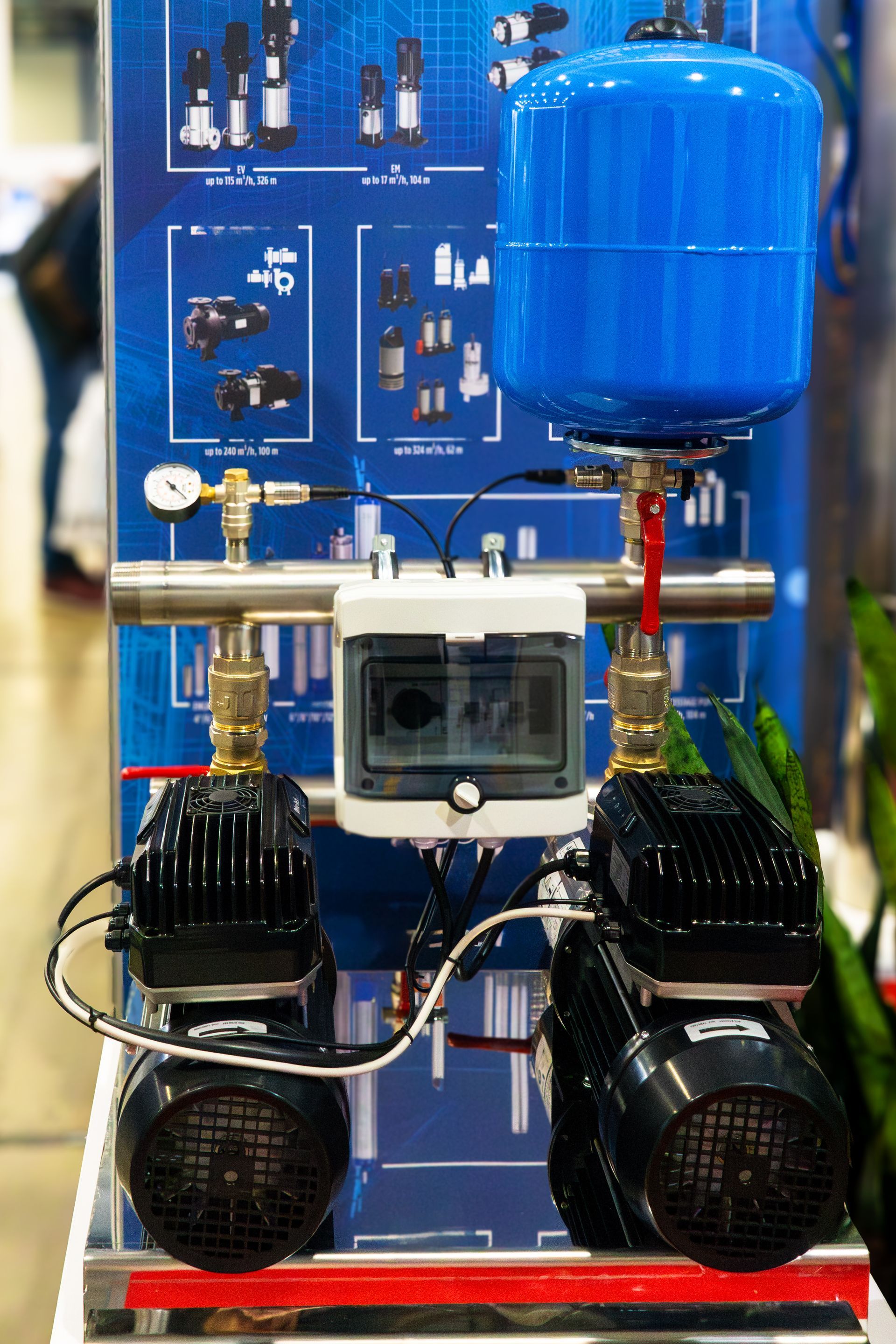 Blue industrial air compressor with twin black motors and a tank on a display stand