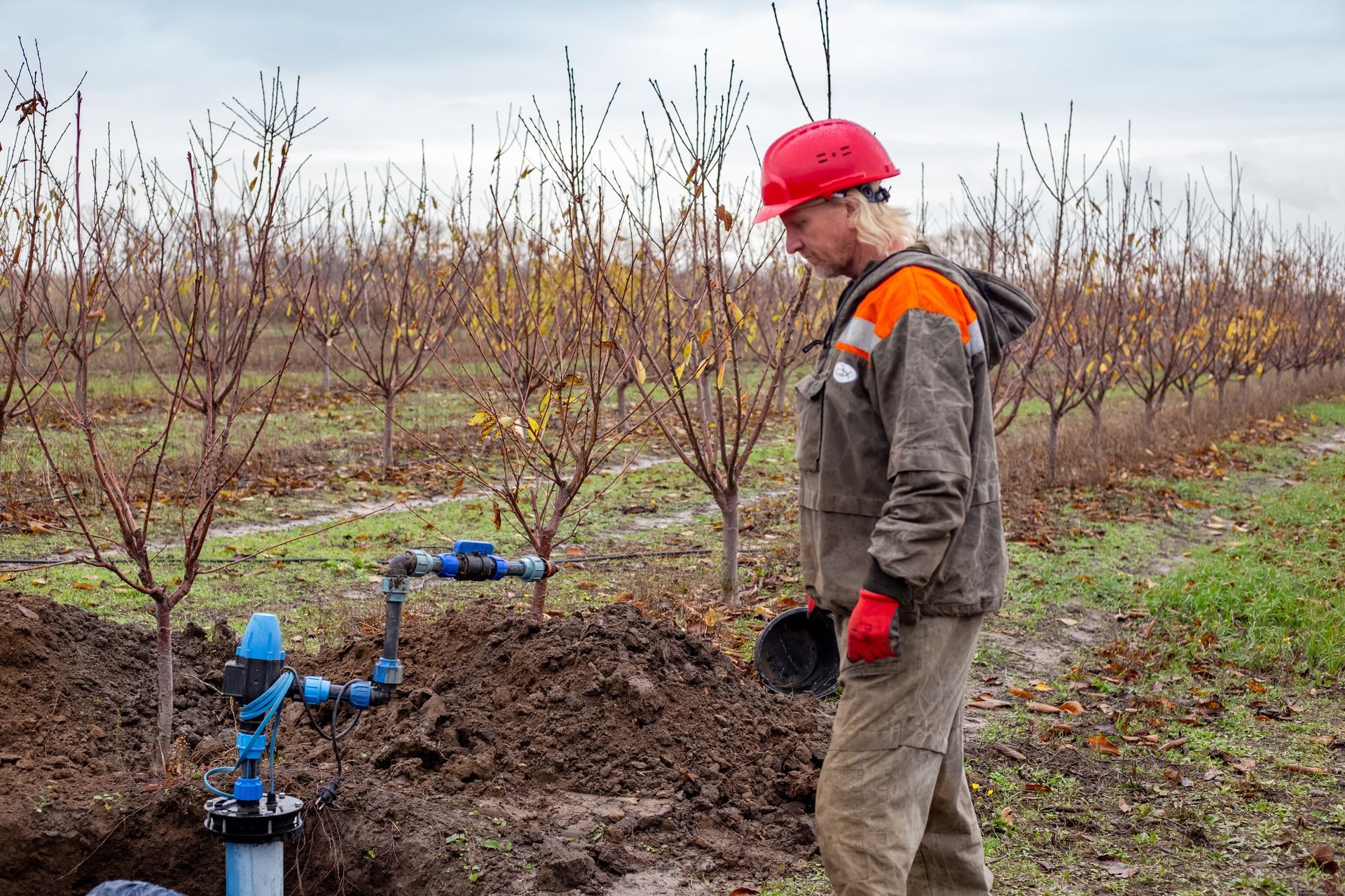 A worker installs a water intake unit in a well.