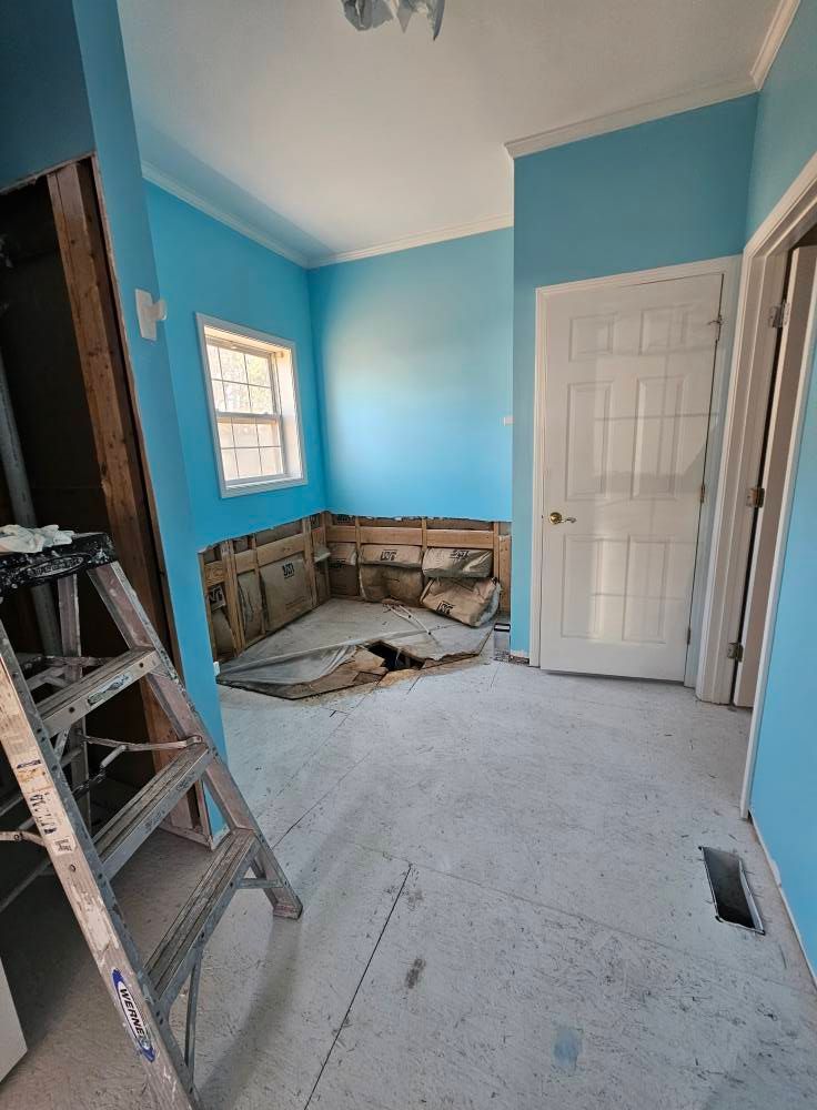 A room with blue walls and a ladder in it.