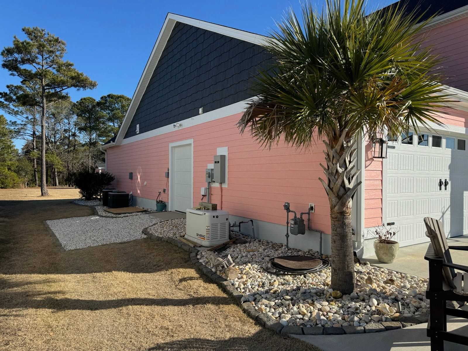A pink house with a palm tree in front of it