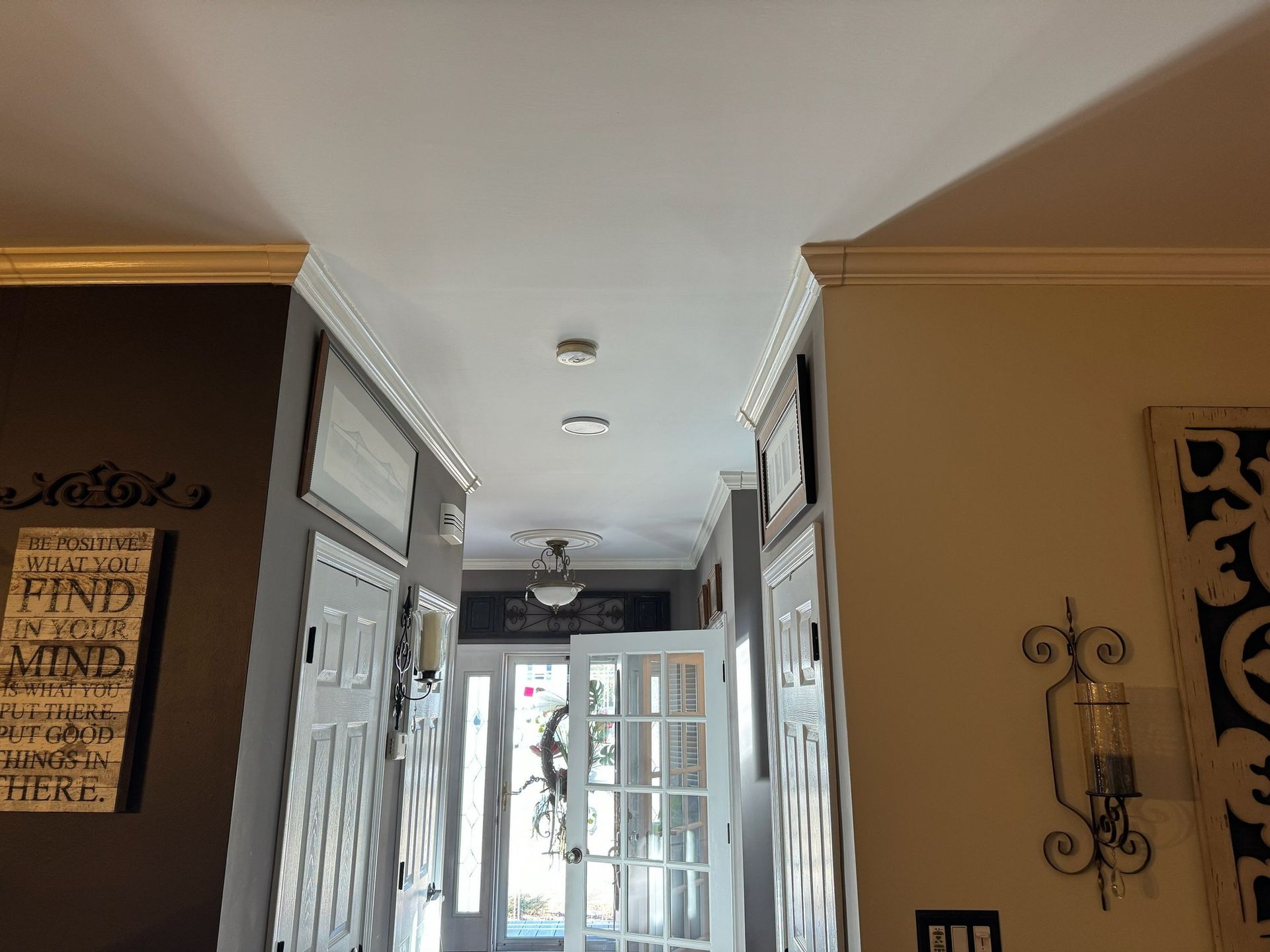 A hallway in a house with a sign on the wall that says 