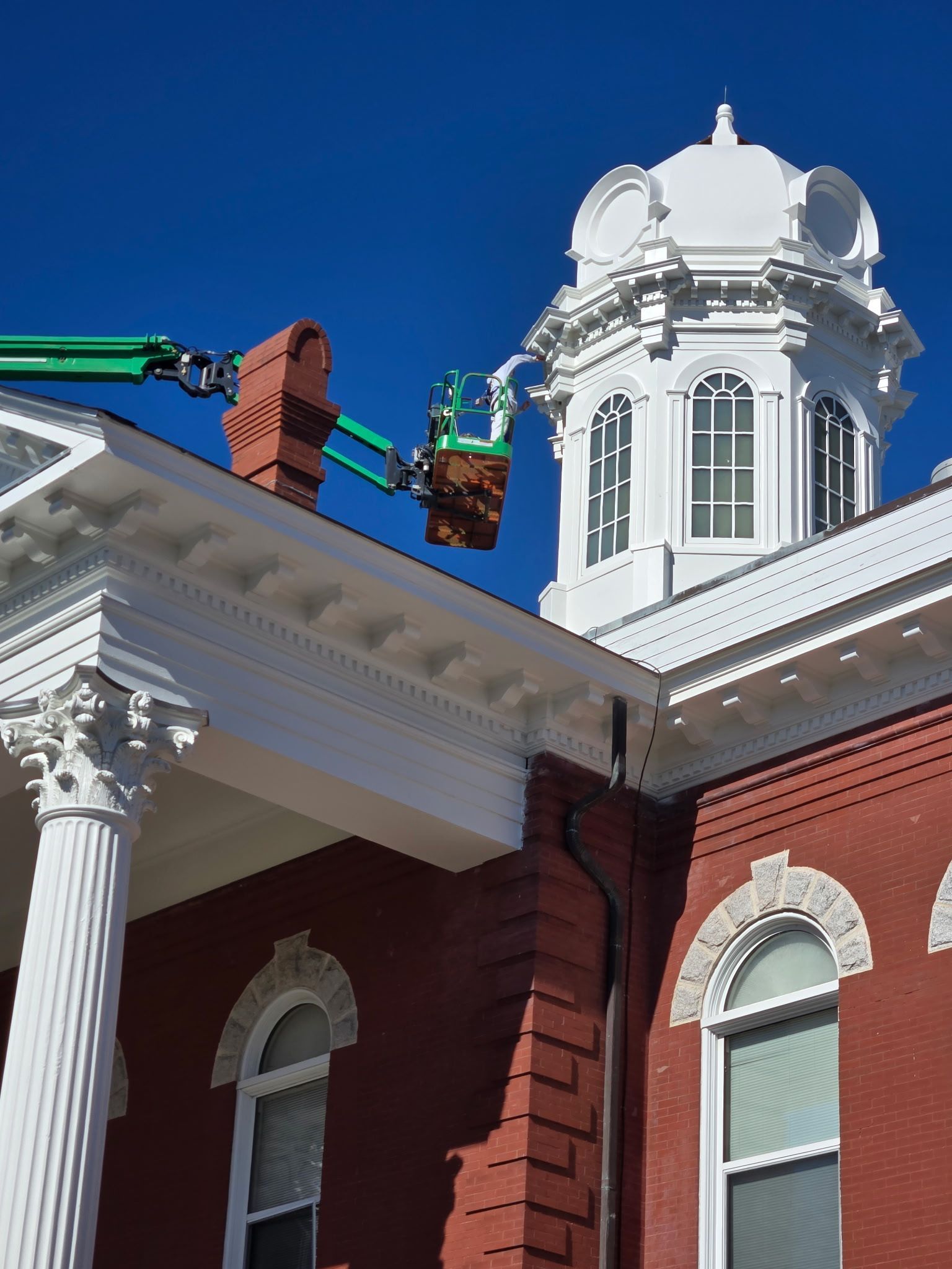 A man is working on the roof of a building