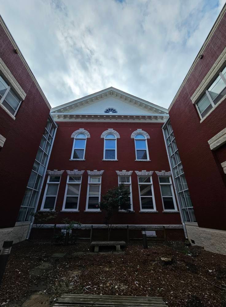 Looking up at a large red building with a lot of windows
