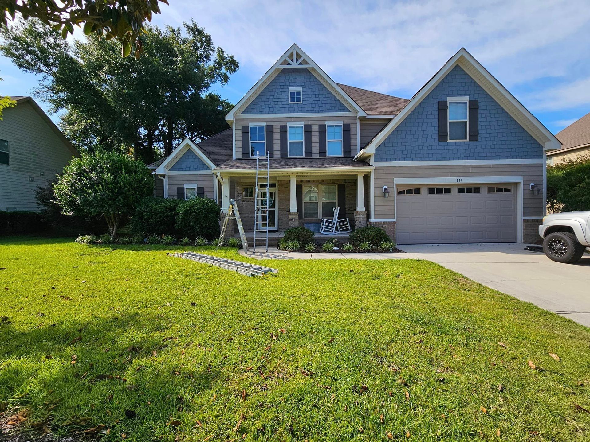 A large house with a jeep parked in front of it.