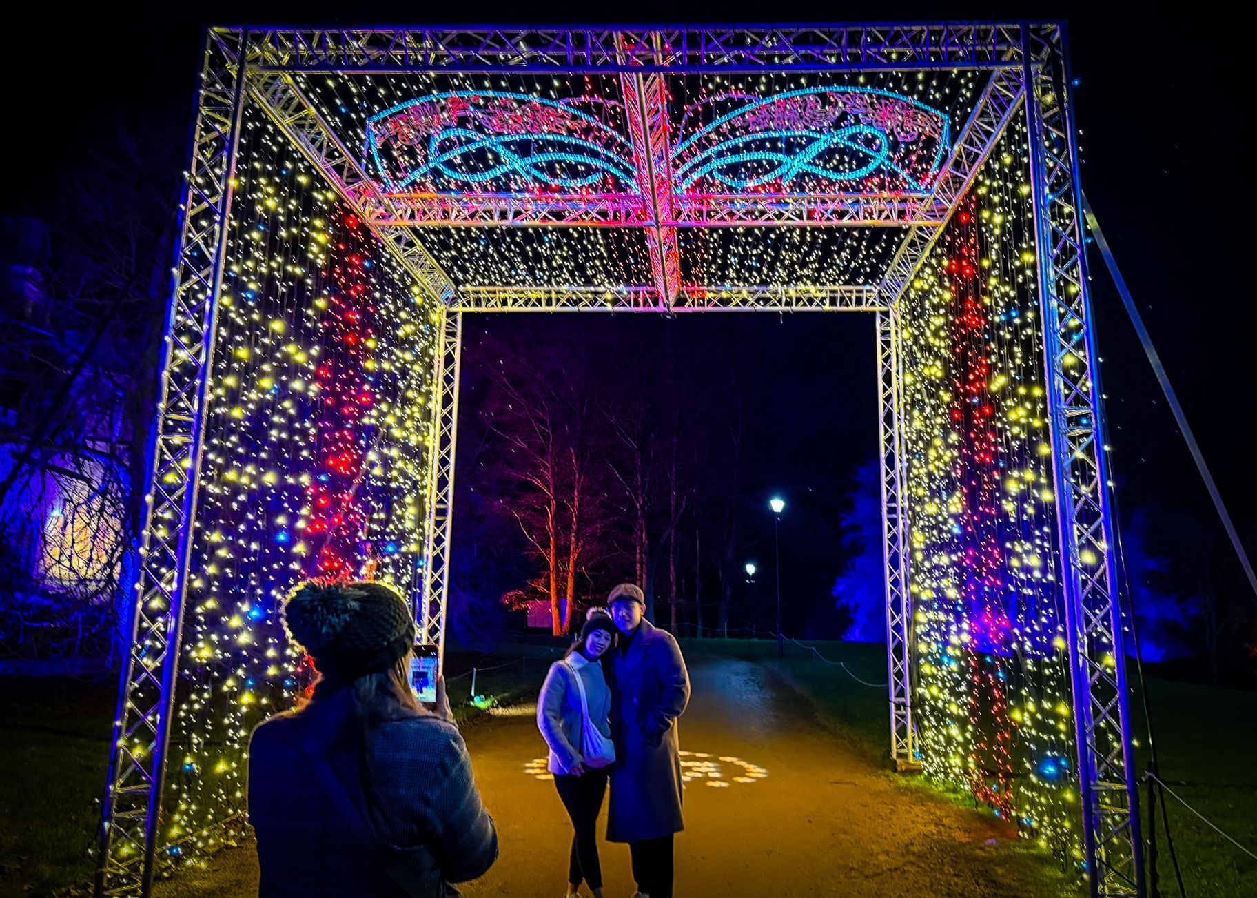 Walk-through 3D structure of giant Christmas present made from fairy-lit box truss.