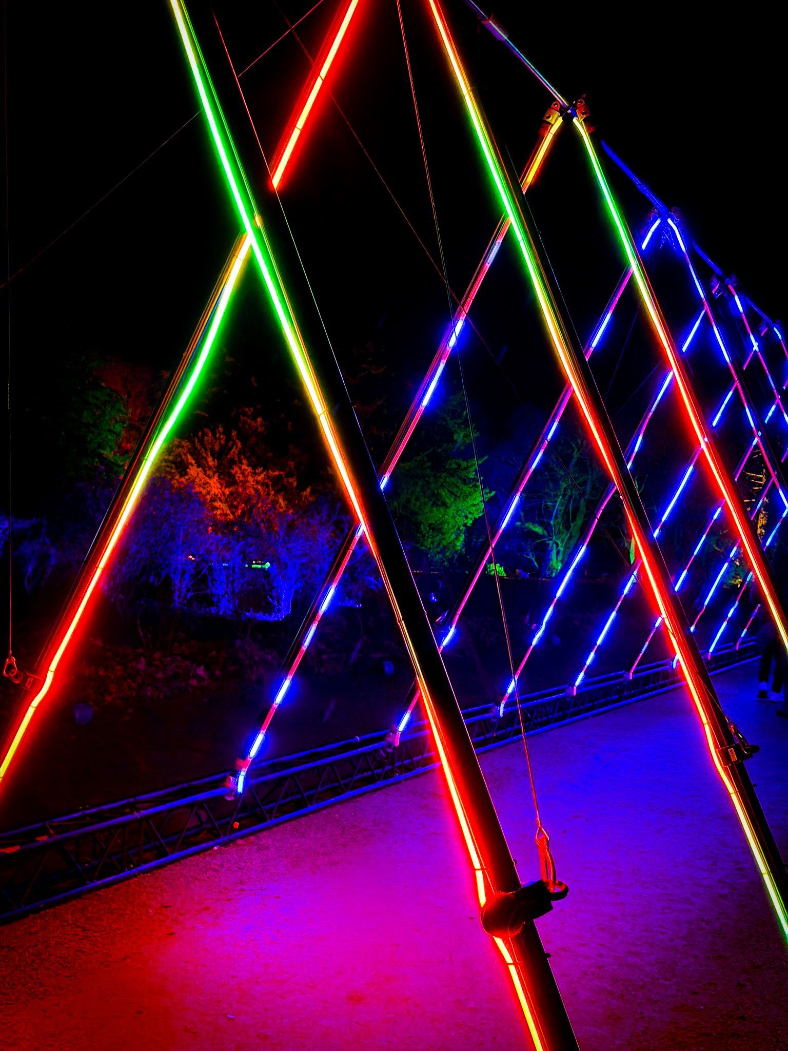 Immersive walk-through with triangular Pixel LED batten arches and 3D moving lights.