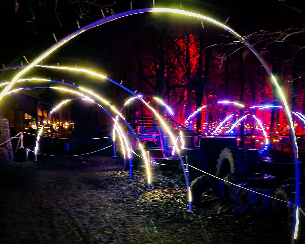 LED lights in running pattern across arches and hoops at event installation.