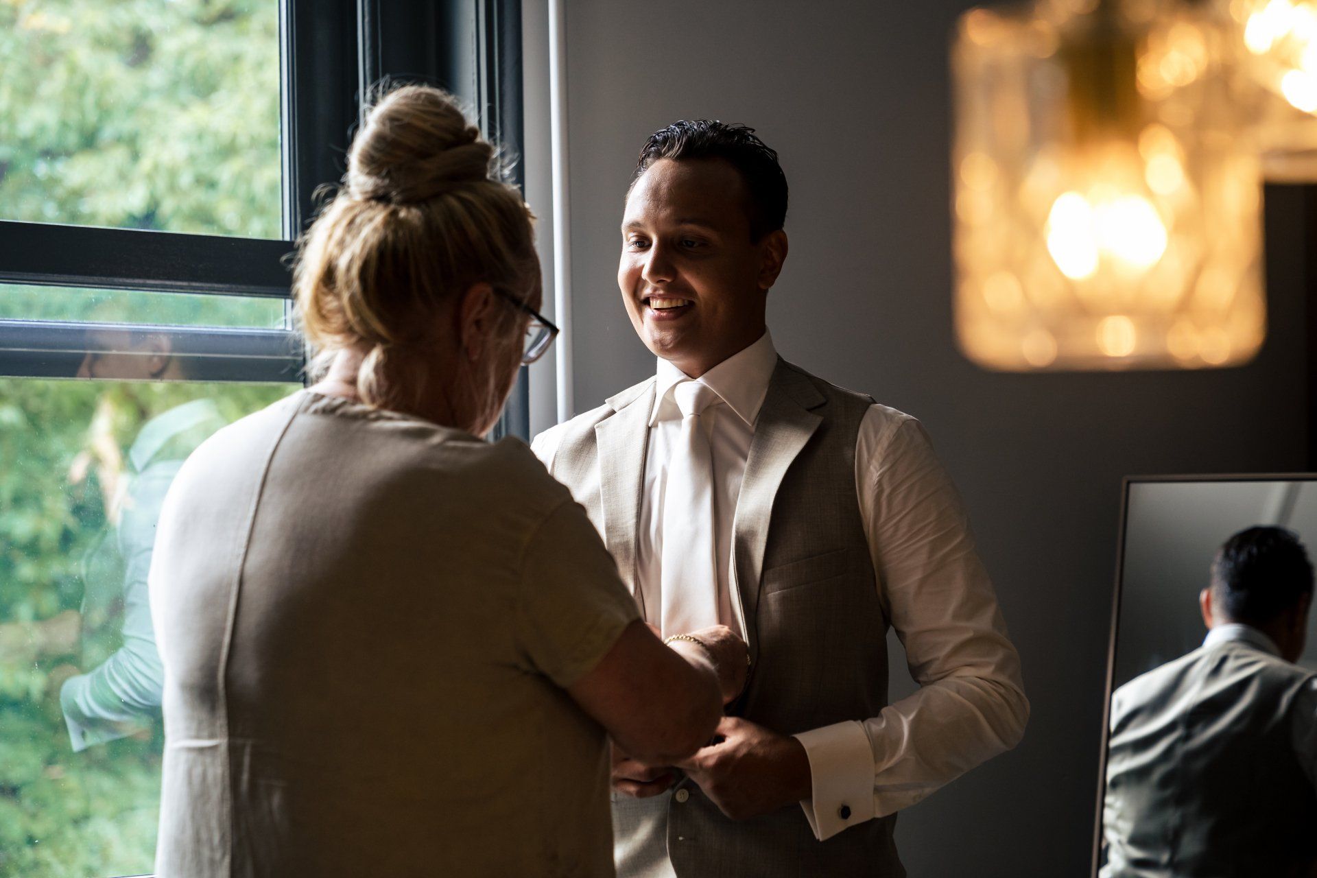 Een man en een vrouw staan ​​naast elkaar voor een raam.