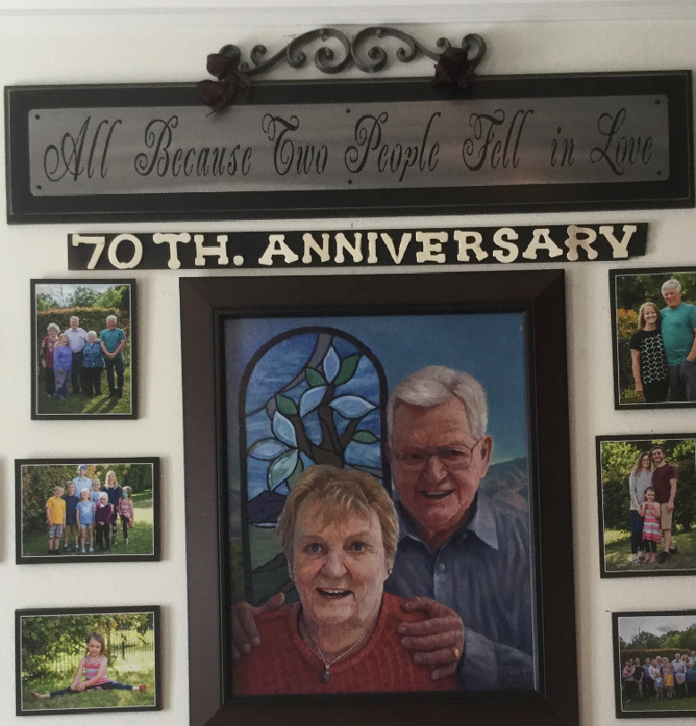 a 70th anniversary sign hangs above a framed picture of a man and woman