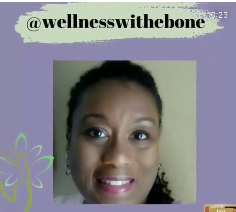 a woman is smiling in front of a sign that says wellnesswithbone