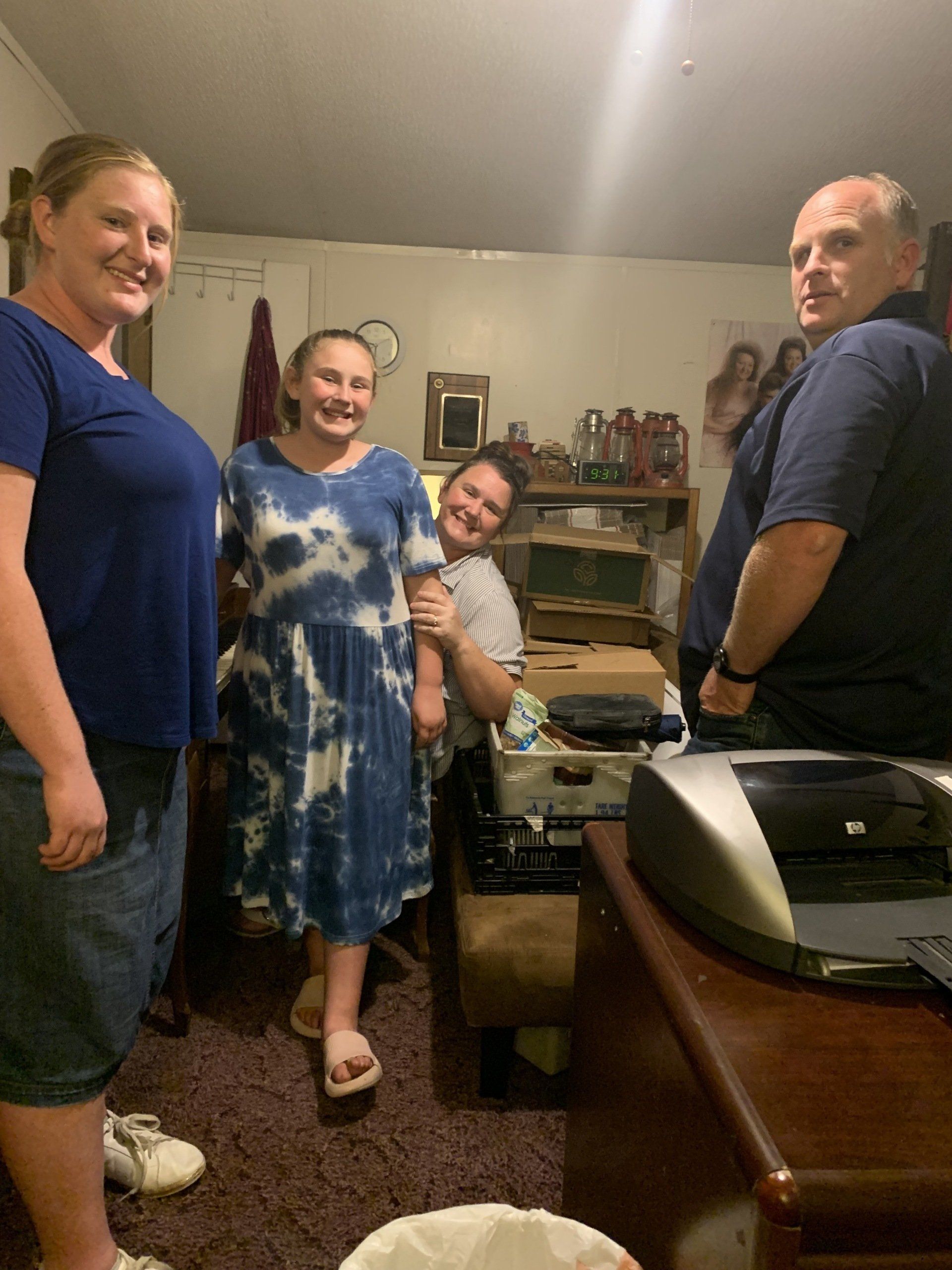 a group of people are posing for a picture in a living room