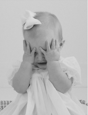 little girl holding her head