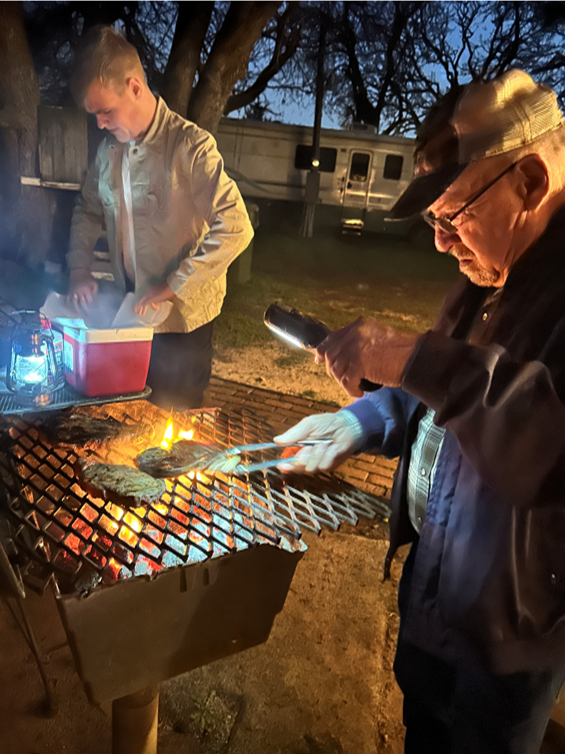 man cooking over a grill