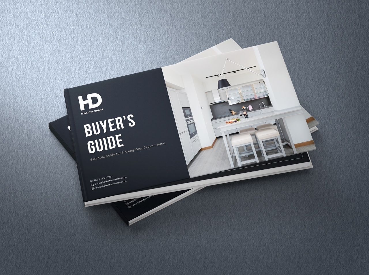 Black-and-white buyer’s guide booklet on a gray surface, showing a modern kitchen interior on the cover.