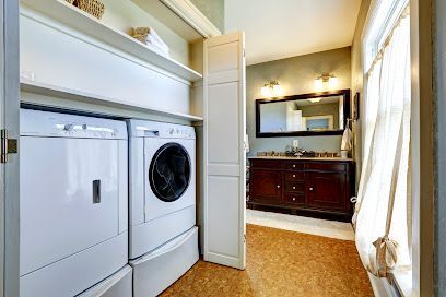 A laundry room with a washer and dryer and a bathroom.