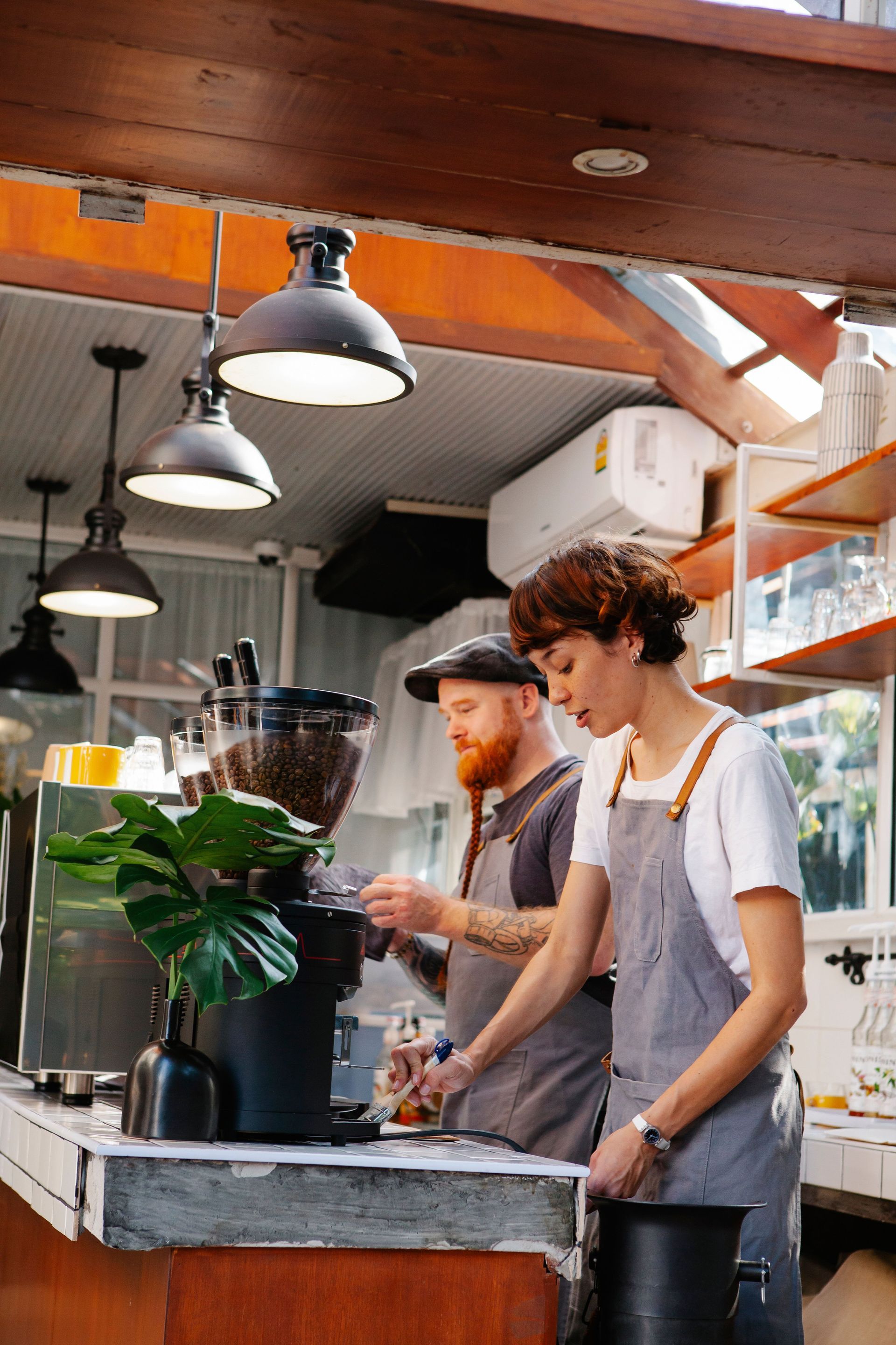A group of people are sitting at tables in a coffee shop.
