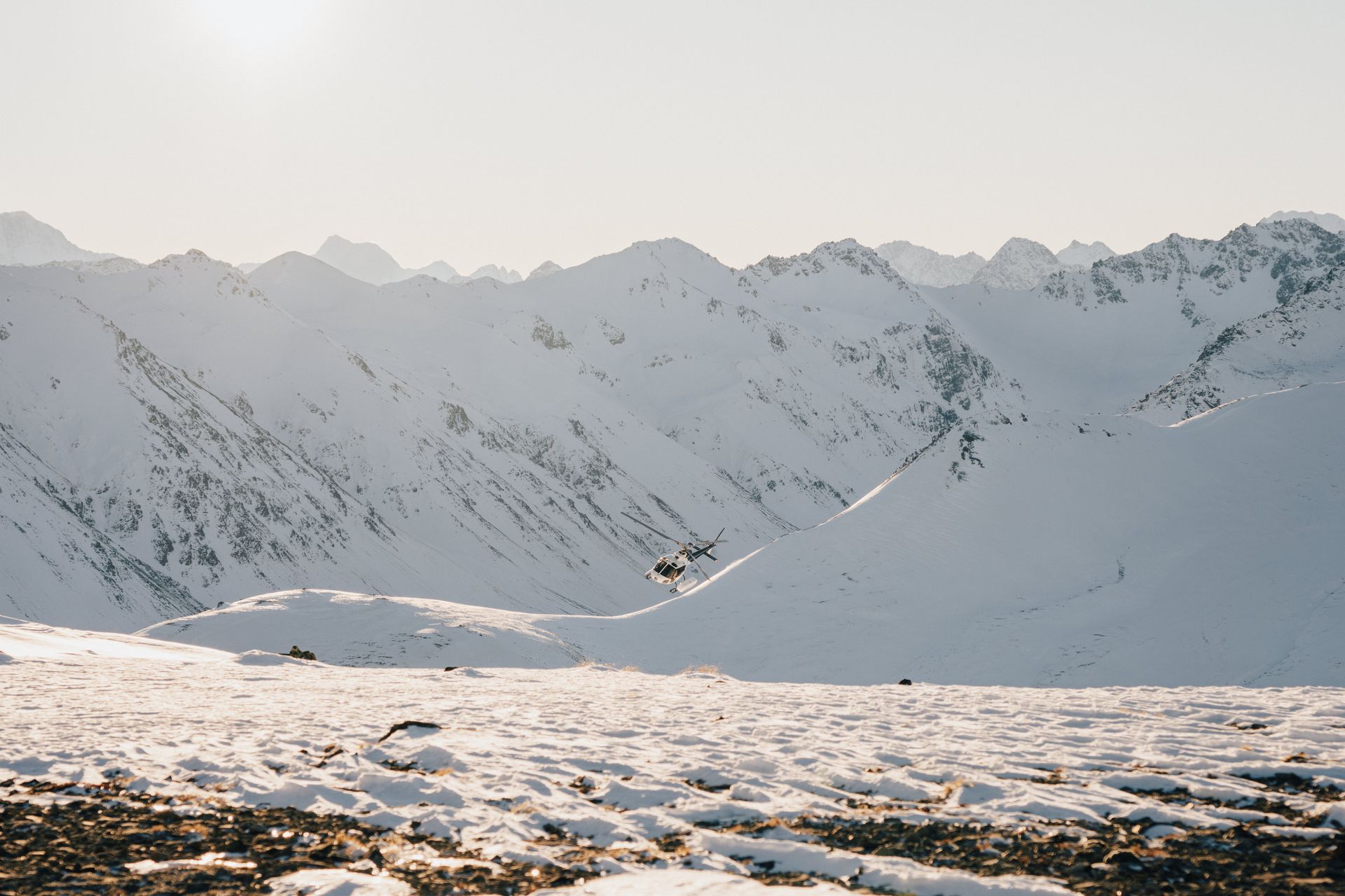 A snowy mountain range with a lot of snow on the ground