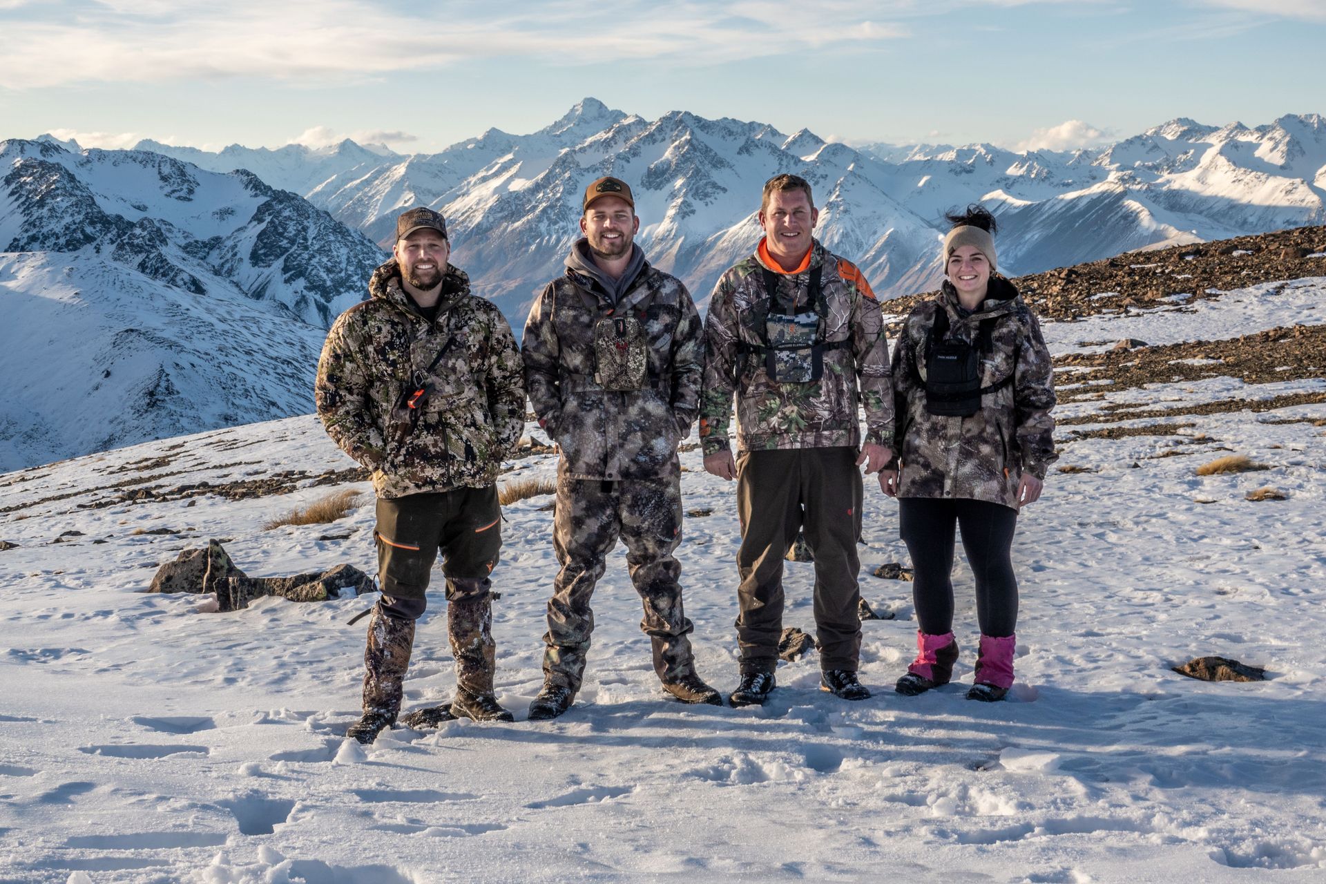 A group of people standing on top of a snow covered mountain. Rival Hunts NZ