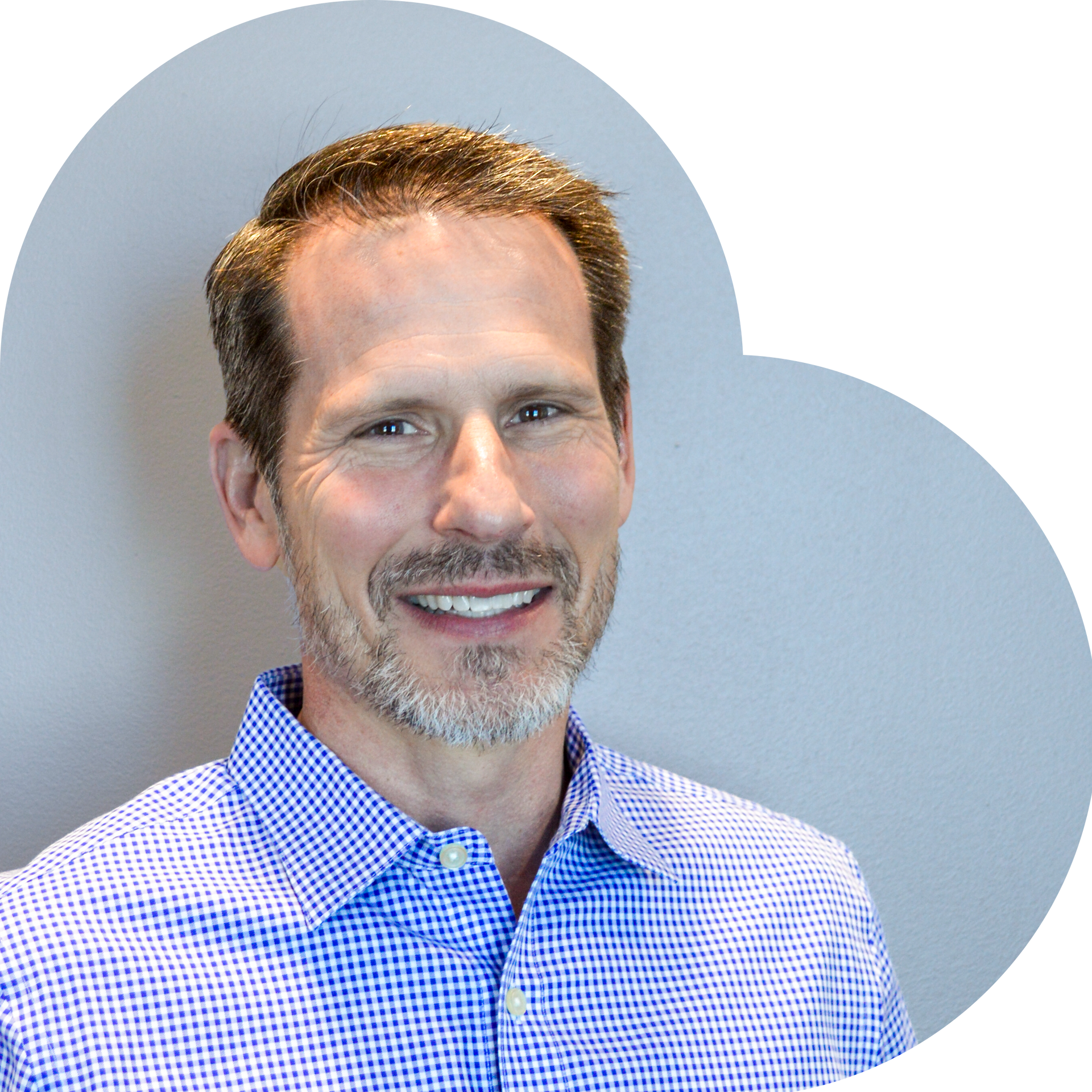 Man in a blue and white checkered shirt smiling