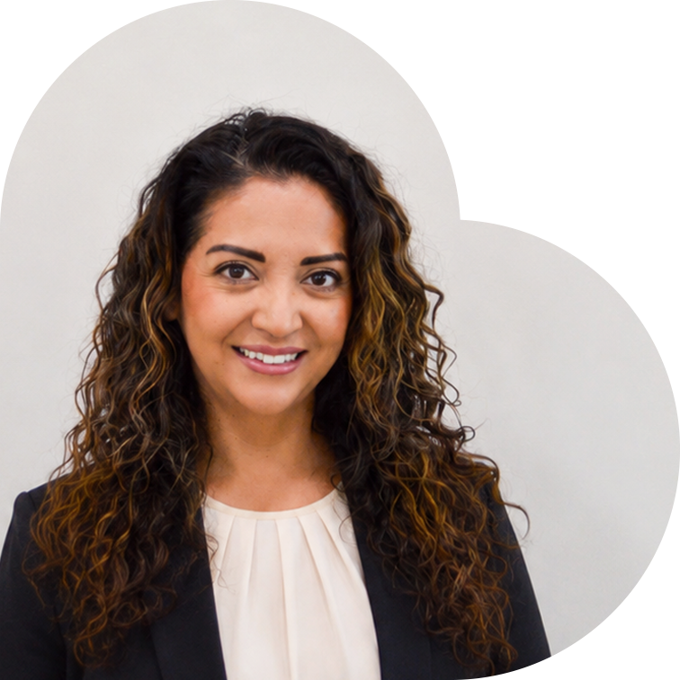 Woman in a black blazer smiling.