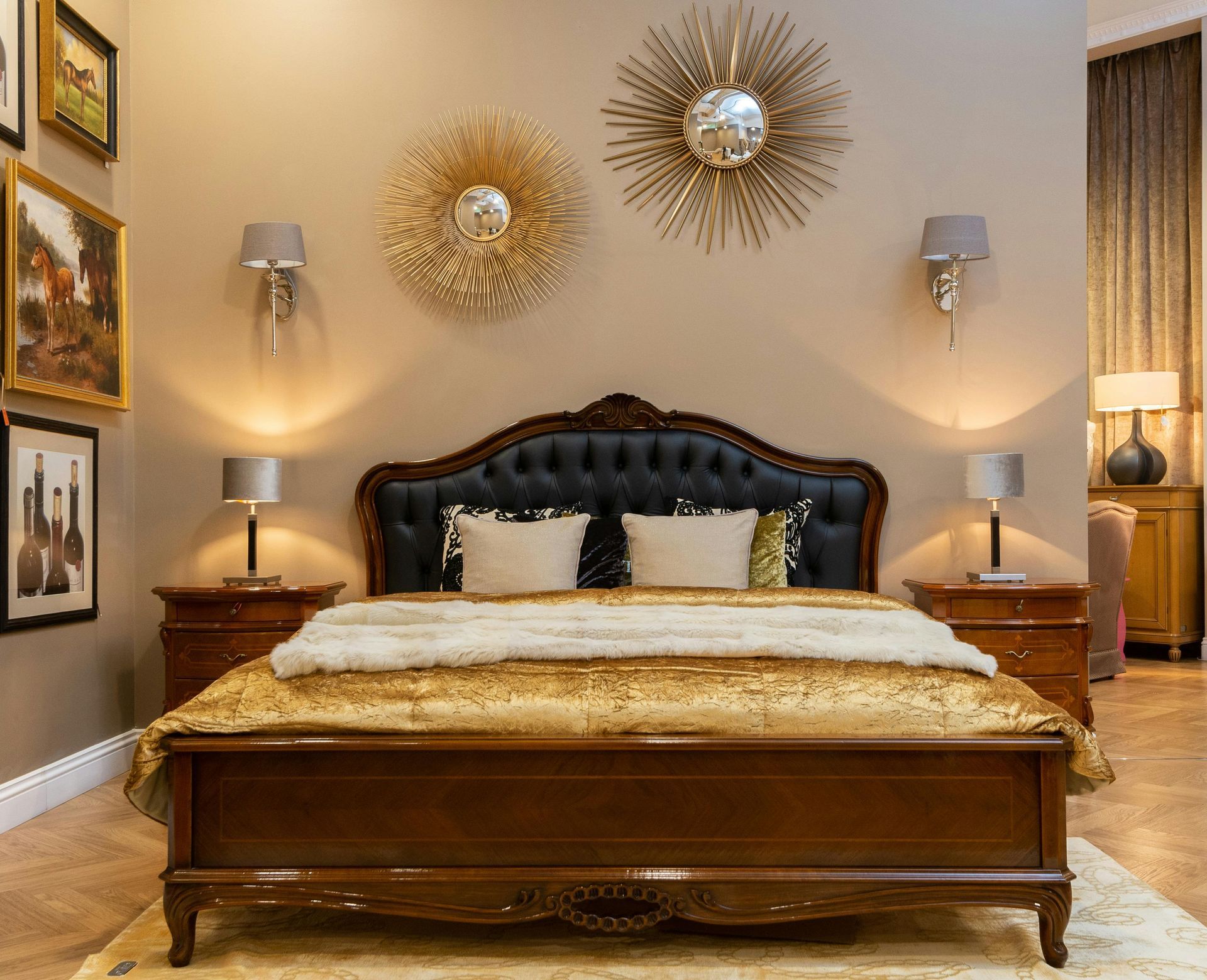 Elegant bedroom with a dark wood bed, tufted headboard, bedside lamps, and gold wall decor