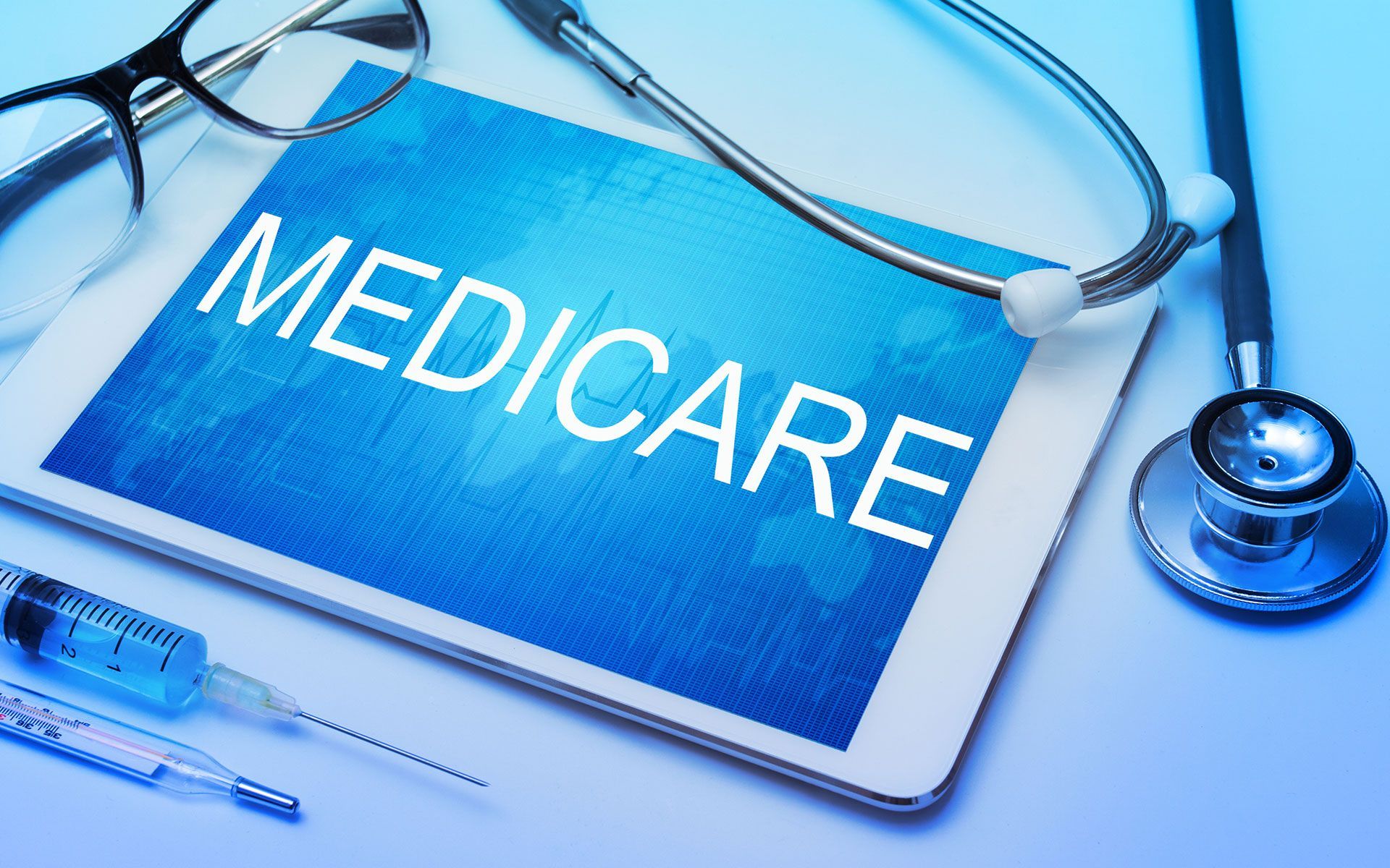 A tablet with the word medicare written on it