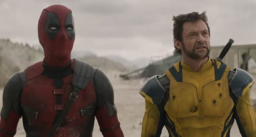 Deadpool and wolverine are standing next to each other in a desert.