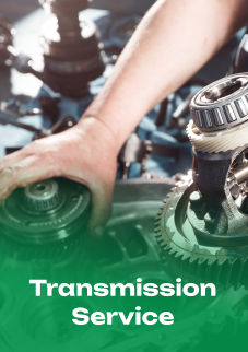 A person is working on a transmission with the words transmission service below them | Emerald Automotive