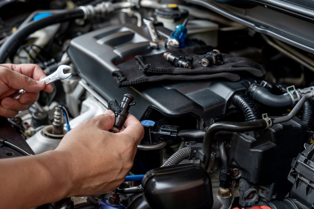 A Person is Working on a Car Engine With a Wrench — Skazas Automotive In Cardiff, NSW