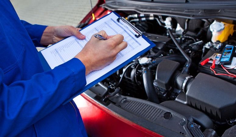 A Mechanic is Writing on a Clipboard — Skazas Automotive In Cardiff, NSW