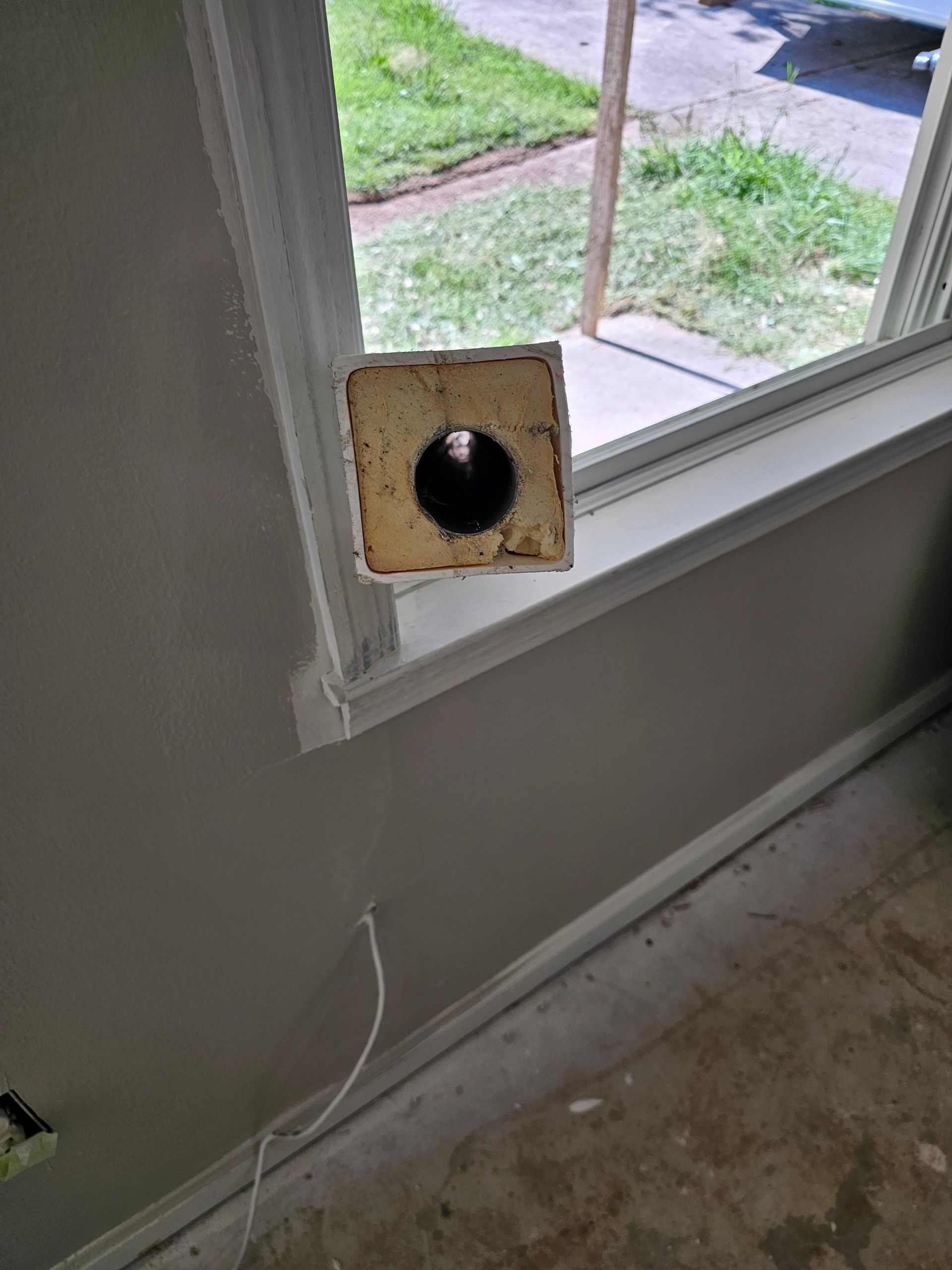 Cutaway view of a window frame with a square, hollow section containing a central hole, showing insulation.