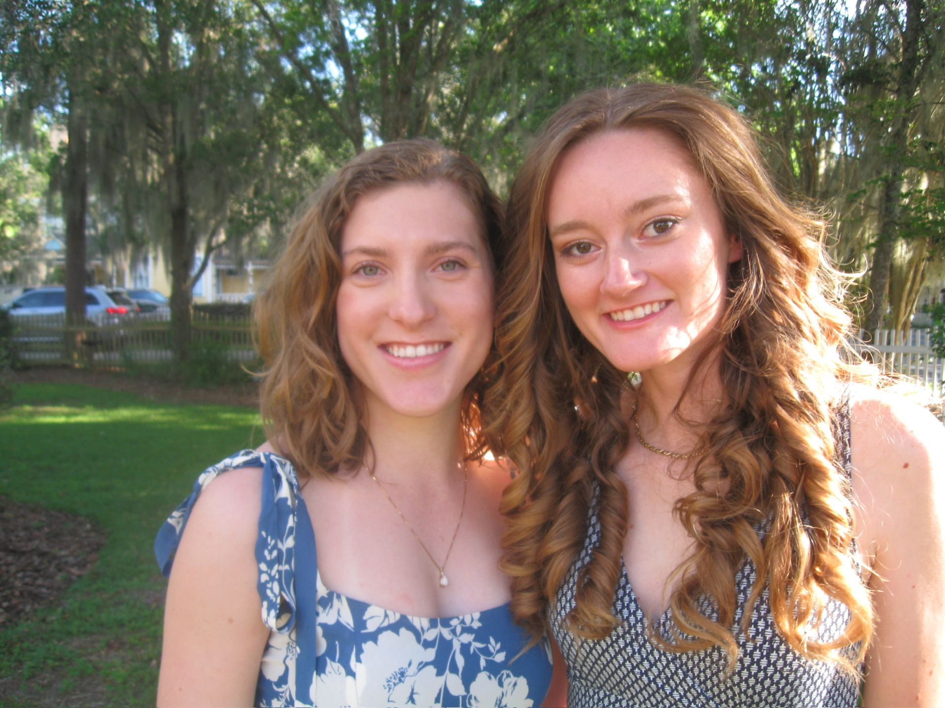 women smiling outside of the camellia rose inn