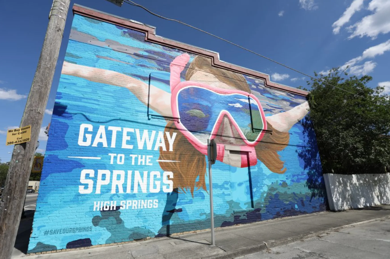 Downtown High Springs sign with snorkeler in springs