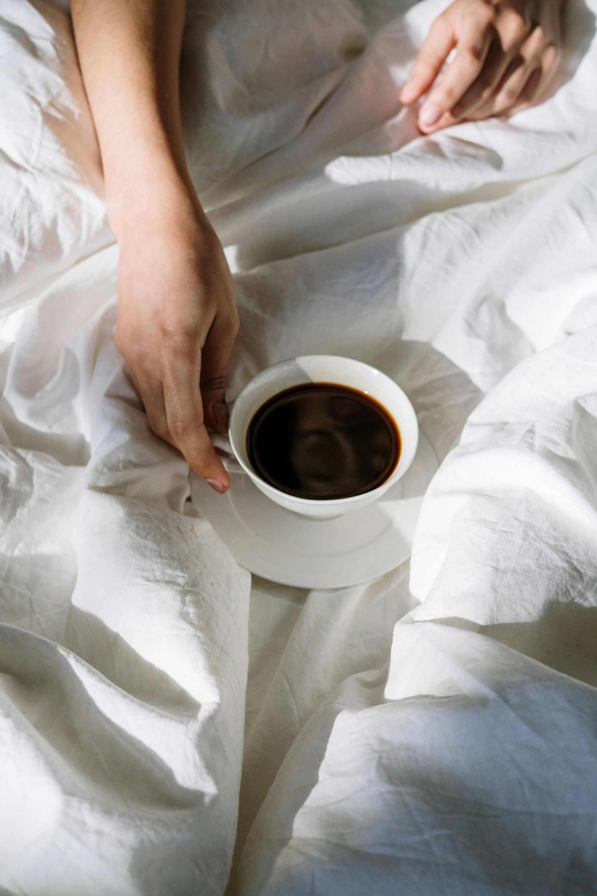 A woman having coffee in bed