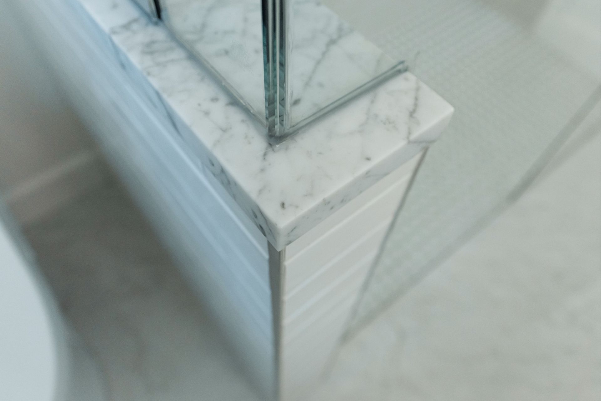 Glass corner on a white marble base in a modern interior