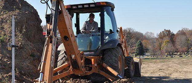 Man on Excavator Truck — Plymouth, IN — Creed Septic System Specialist Man on Excavator Truck — Plymouth, IN — Creed Septic System Specialist