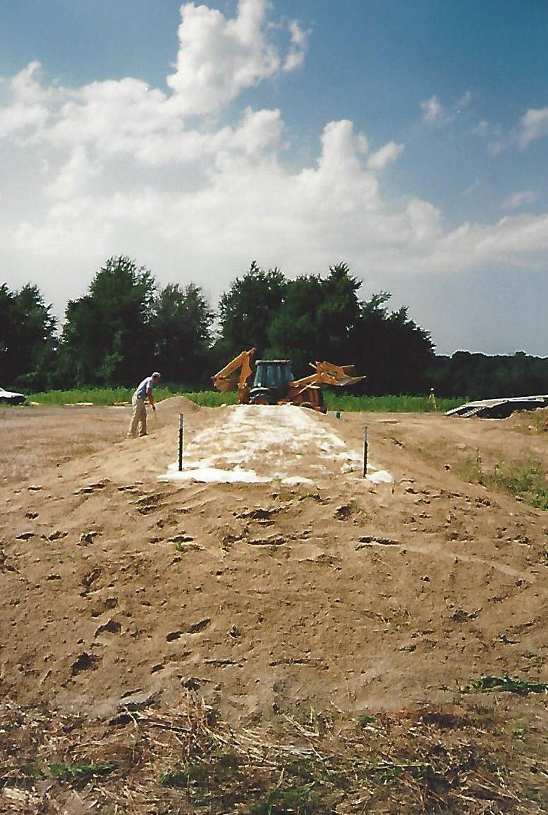 Worker and Excavator Trucks — Plymouth, IN — Creed Septic System Specialist