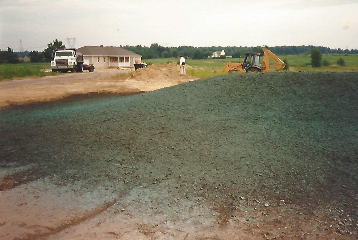 Worker on the Ground Field — Plymouth, IN — Creed Septic System Specialist