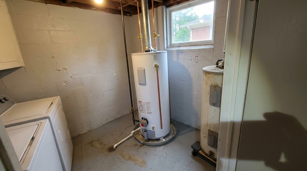 Utility room with water heater, washing machine, and small window