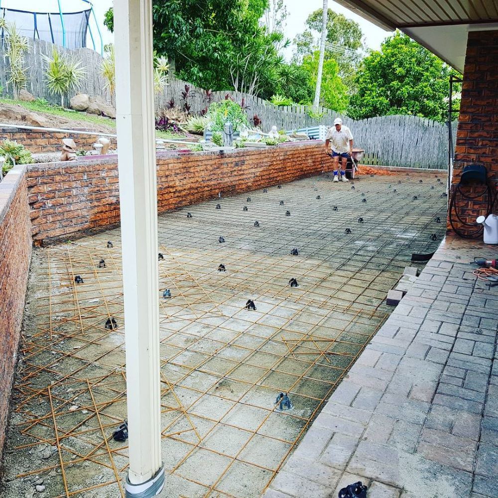 A Person is Working on a Patio Construction Project — TJ Concreting in Northern Rivers, NSW