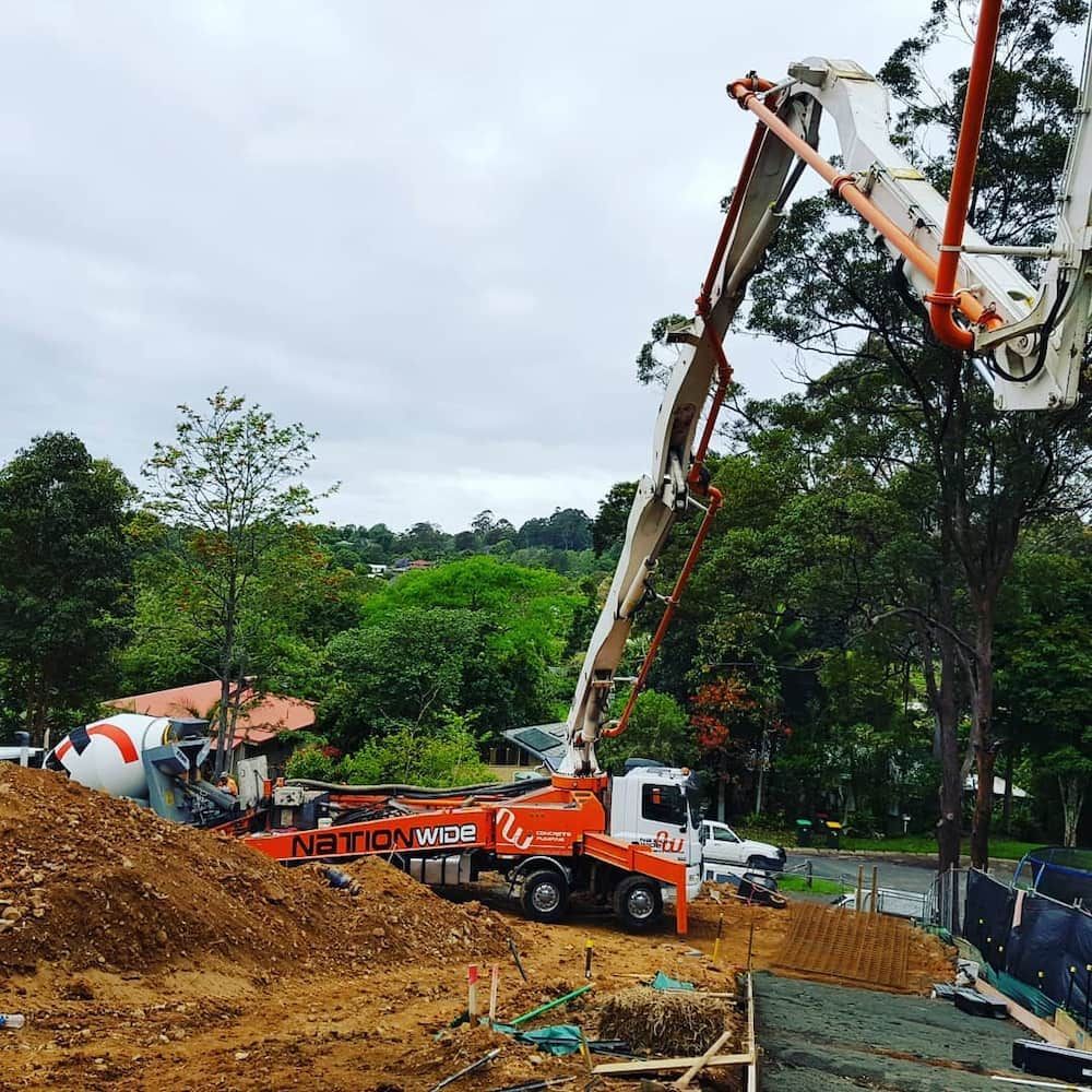 A Concrete Pump is Being Used on a Construction Site — TJ Concreting in Grafton, NSW