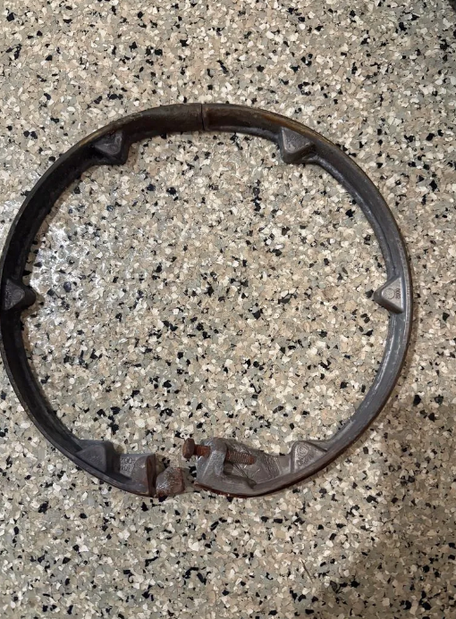 Broken metal ring on a speckled countertop.