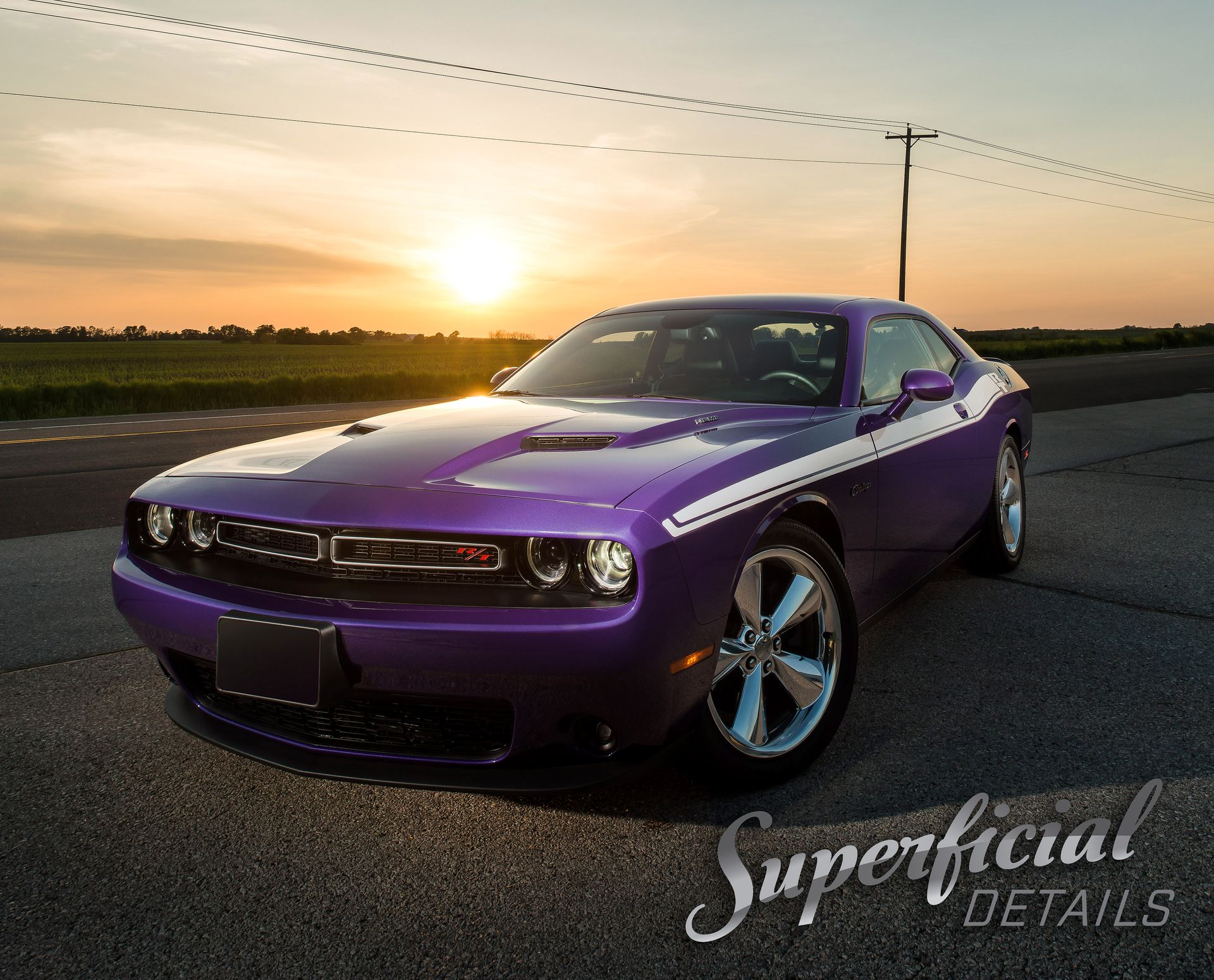 Purple Dodge Challenger parked at sunset on a road, with a watermark in the lower right.
