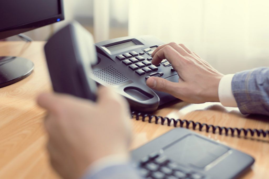 office worker using land line phone