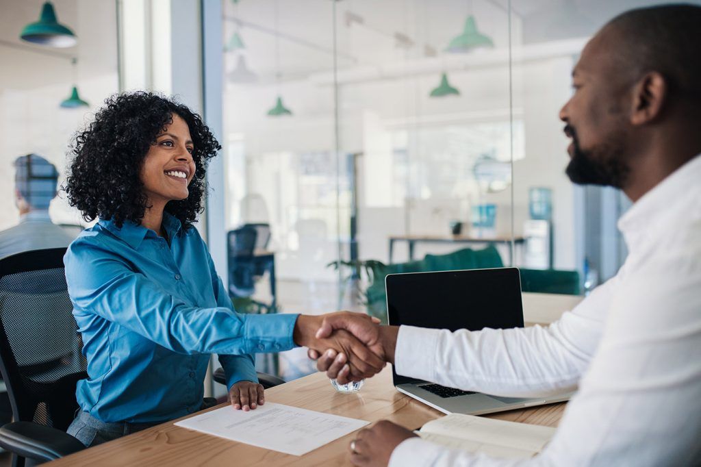 satisfied customer shaking hands with manager