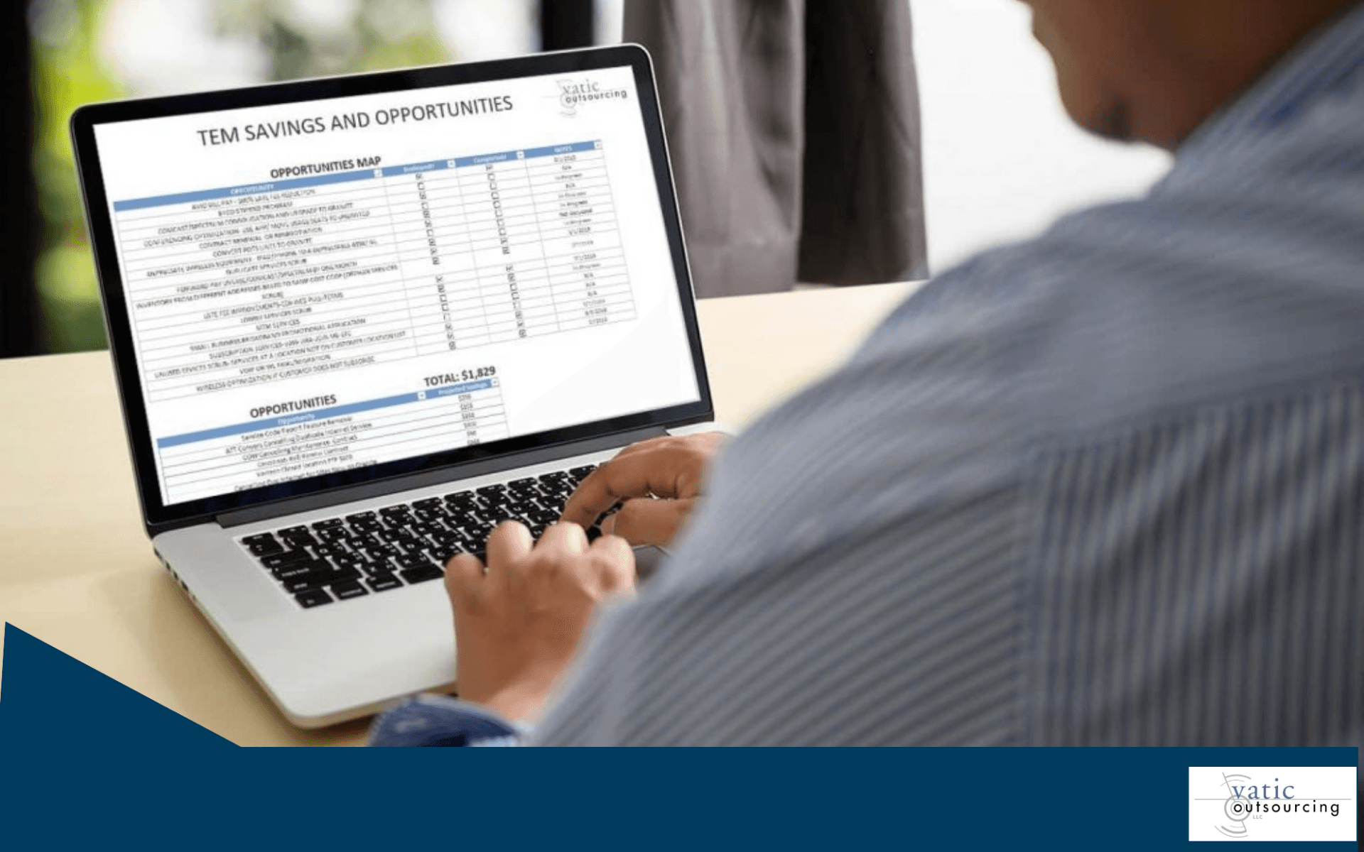 person working on laptop spreadsheet
