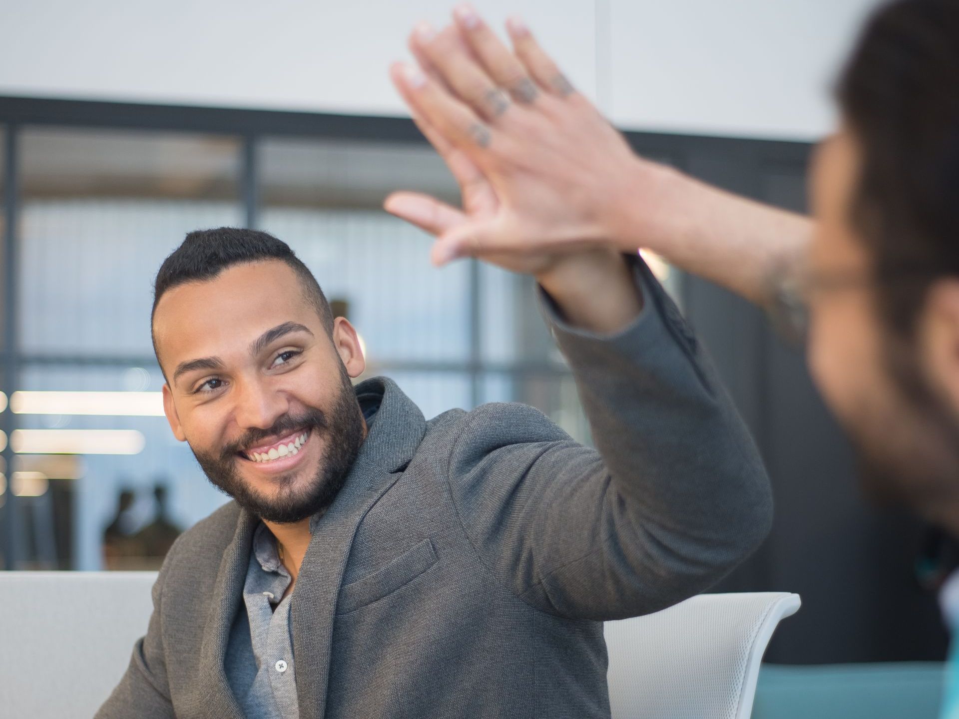 2 men high fiving