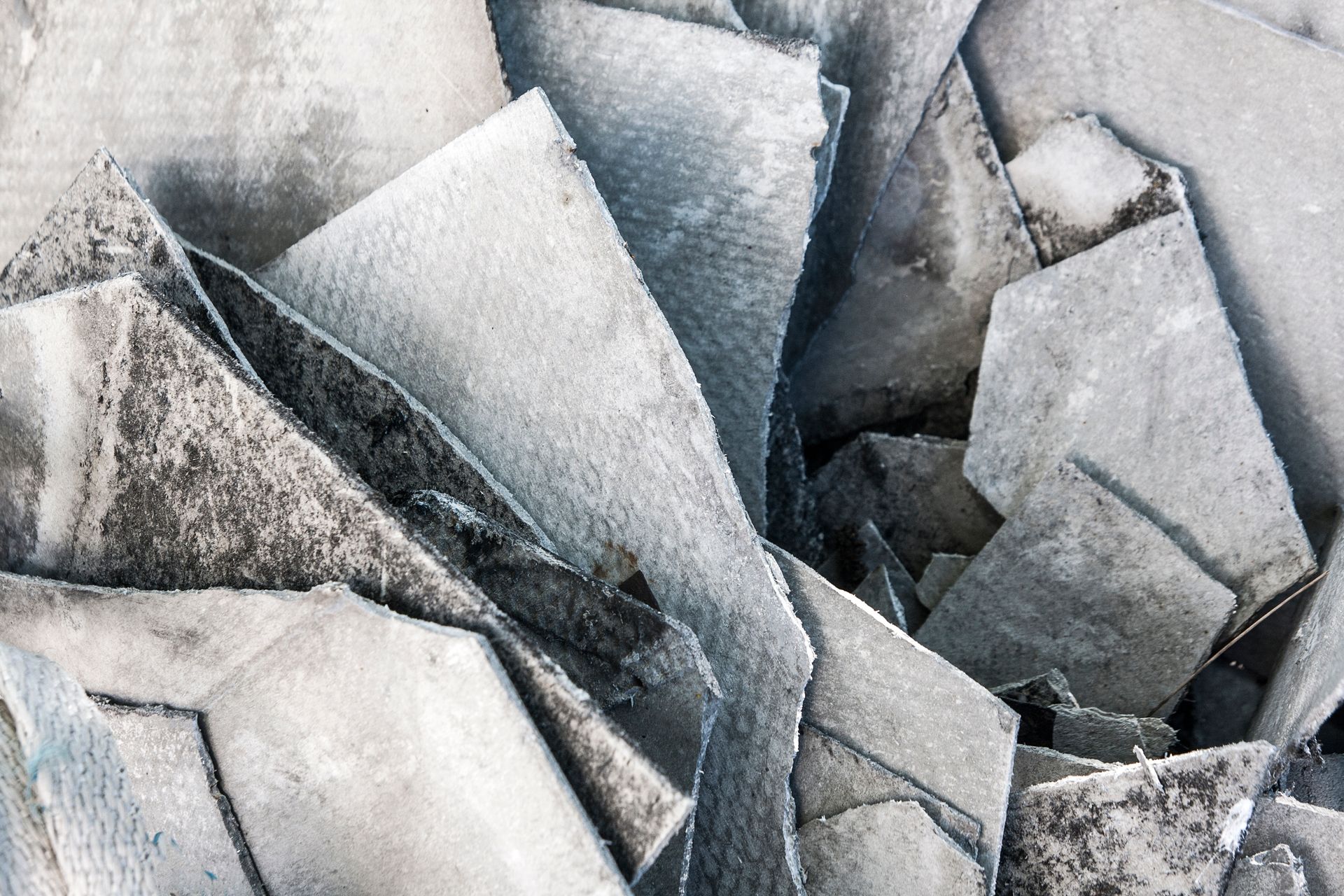 Abstract close-up of overlapping gray and white angular stone or ice shards