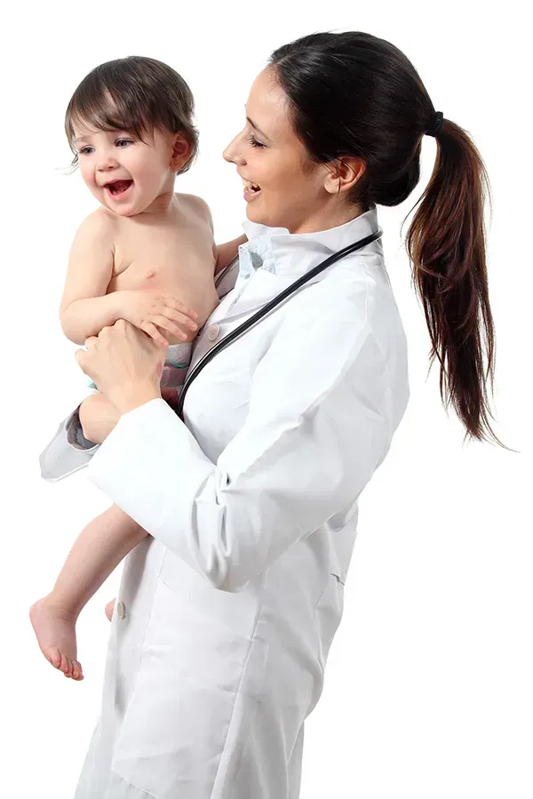 A female doctor is holding a baby in her arms.