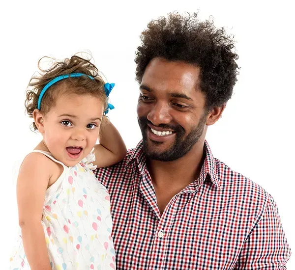 A man in a plaid shirt is holding a little girl